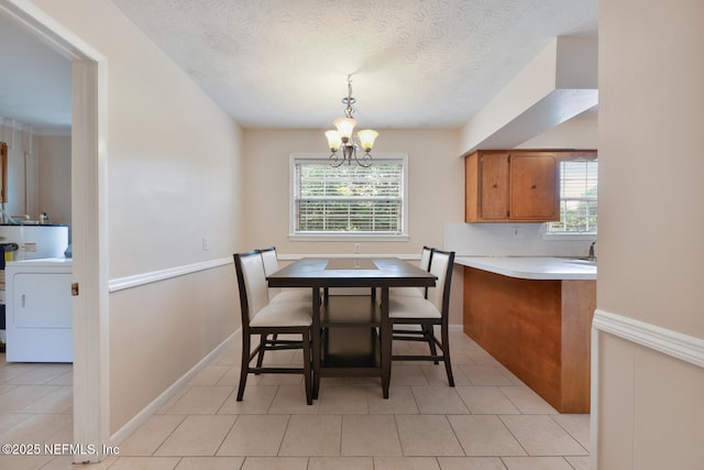 10870 High Ridge Rd, Jacksonville, FL 32225 - dining area with a textured ceiling, a healthy amount of sunlight, an inviting chandelier, and washer / dryer