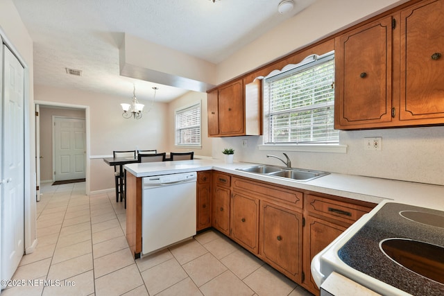 10870 High Ridge Rd, Jacksonville, FL 32225 - kitchen with visible vents, brown cabinets, range with electric cooktop, dishwasher, and a sink