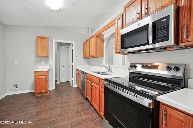 117 Sterling Hill Dr, Jacksonville, FL 32225 - kitchen with dark wood-style floors, a textured ceiling, light countertops, appliances with stainless steel finishes, and a sink