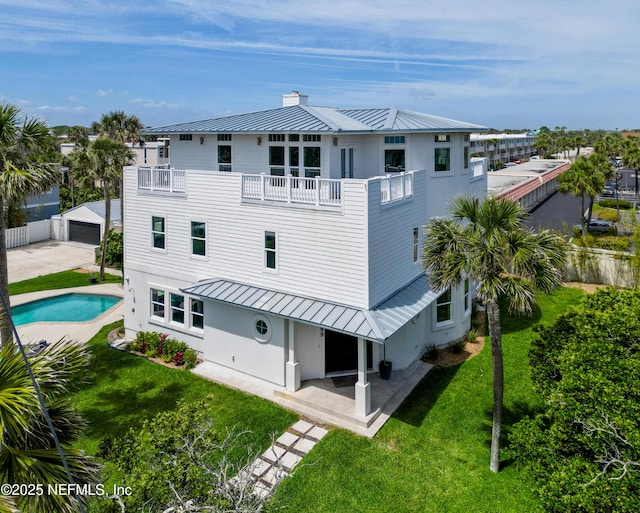 890 Beach Ave, Atlantic Beach, FL 32233 - back of property featuring a patio, a balcony, a standing seam roof, a yard, and metal roof
