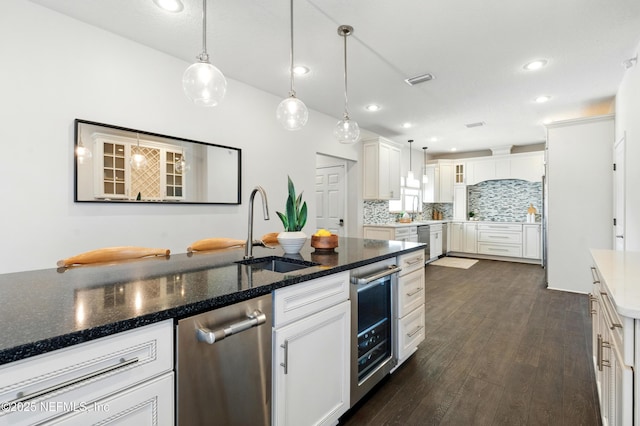 890 Beach Ave, Atlantic Beach, FL 32233 - kitchen with white cabinets, a sink, dark wood-style floors, backsplash, and beverage cooler