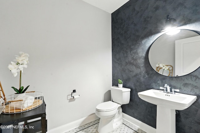 890 Beach Ave, Atlantic Beach, FL 32233 - bathroom featuring toilet, a sink, and baseboards