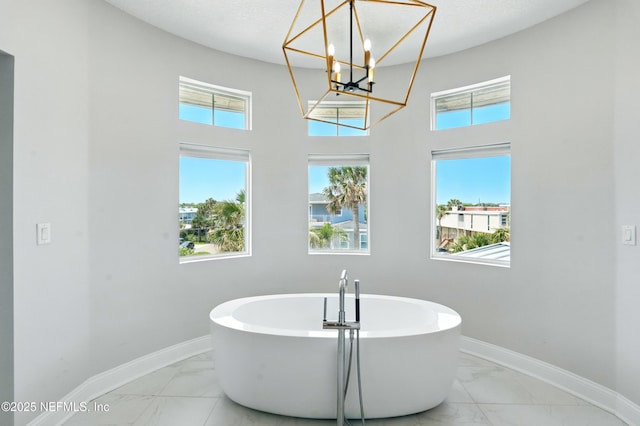 890 Beach Ave, Atlantic Beach, FL 32233 - full bath featuring a chandelier, marble finish floor, baseboards, and a soaking tub