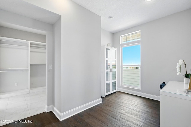 890 Beach Ave, Atlantic Beach, FL 32233 - interior space with a textured ceiling, wood finished floors, and baseboards