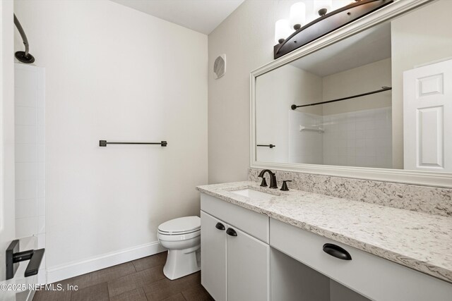 10961 Burnt Mill Rd Unit 622, Jacksonville, FL 32256 - bathroom featuring toilet, vanity, baseboards, and walk in shower