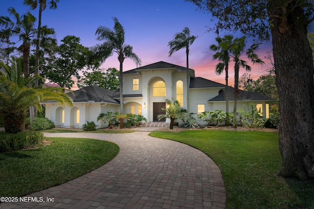 13648 Marsh Harbor Dr N, Jacksonville, FL 32225 - view of front facade with a yard, curved driveway, and stucco siding