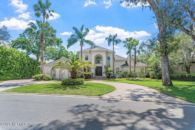 13648 Marsh Harbor Dr N, Jacksonville, FL 32225 - mediterranean / spanish home with a front yard, stucco siding, and curved driveway