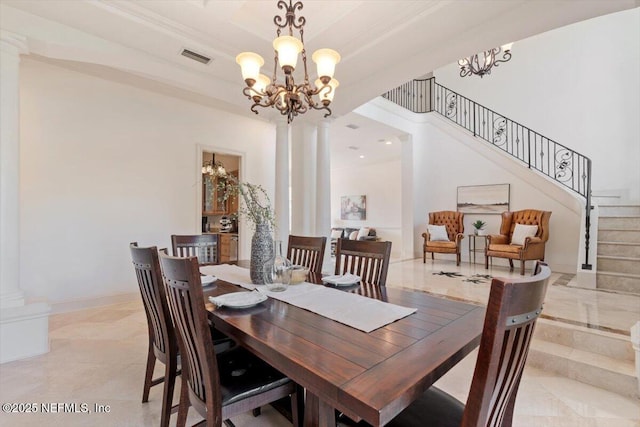 13648 Marsh Harbor Dr N, Jacksonville, FL 32225 - dining room with ornate columns, an inviting chandelier, visible vents, and stairs