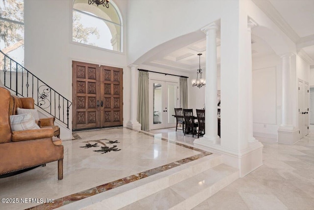 13648 Marsh Harbor Dr N, Jacksonville, FL 32225 - foyer entrance with arched walkways, ornate columns, a towering ceiling, stairway, and marble finish floor