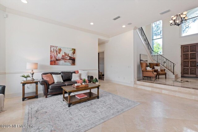 13648 Marsh Harbor Dr N, Jacksonville, FL 32225 - living room with a chandelier, stairs, visible vents, and a high ceiling