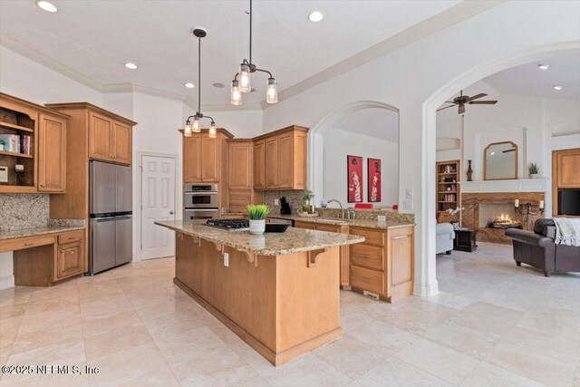 13648 Marsh Harbor Dr N, Jacksonville, FL 32225 - kitchen featuring arched walkways, a kitchen island, appliances with stainless steel finishes, open floor plan, and a breakfast bar area