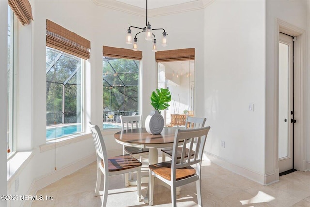 13648 Marsh Harbor Dr N, Jacksonville, FL 32225 - dining area with ornamental molding, baseboards, a notable chandelier, and a healthy amount of sunlight