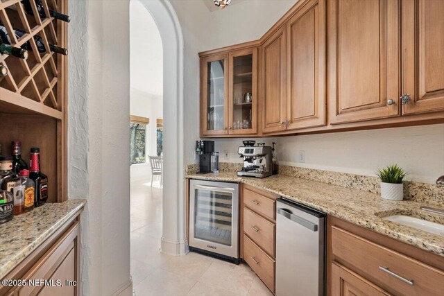 13648 Marsh Harbor Dr N, Jacksonville, FL 32225 - kitchen with glass insert cabinets, light stone countertops, arched walkways, dishwasher, and wine cooler