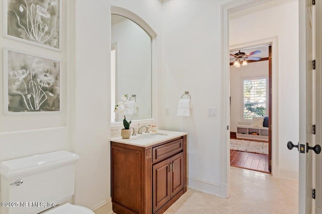 13648 Marsh Harbor Dr N, Jacksonville, FL 32225 - bathroom with vanity, a ceiling fan, toilet, tile patterned floors, and baseboards