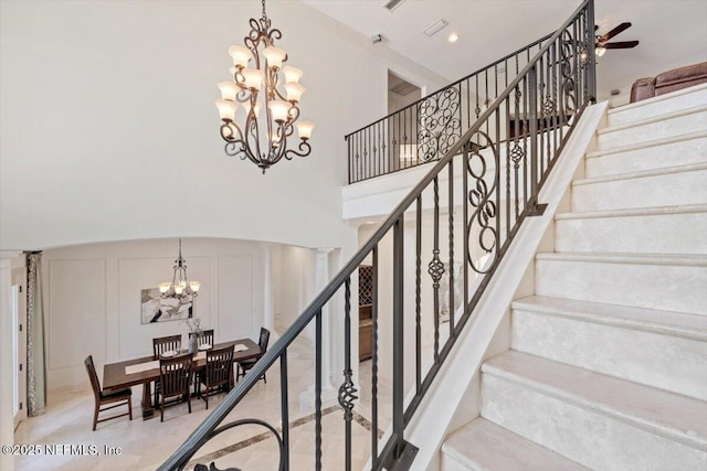 13648 Marsh Harbor Dr N, Jacksonville, FL 32225 - stairway featuring a decorative wall, recessed lighting, a towering ceiling, and ceiling fan with notable chandelier