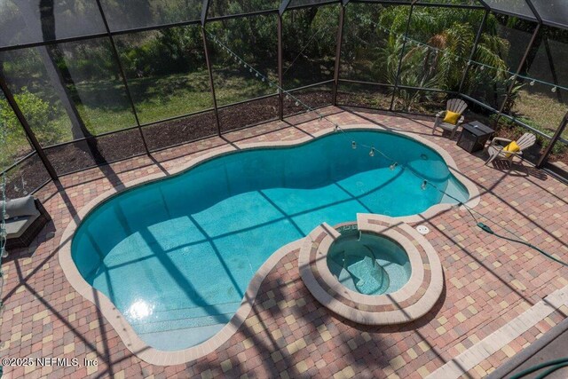 13648 Marsh Harbor Dr N, Jacksonville, FL 32225 - view of swimming pool featuring a patio, a pool with connected hot tub, and glass enclosure