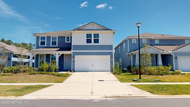 view of front of house with board and batten siding, an attached garage, and concrete driveway