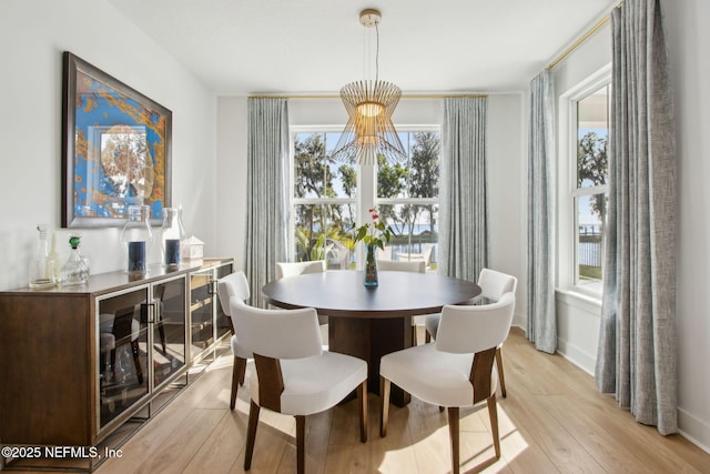 157 Oak Pk Dr, Saint Johns, FL 32259 - dining area with a chandelier, light wood-style floors, and baseboards