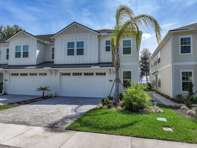 157 Oak Pk Dr, Saint Johns, FL 32259 - multi unit property with driveway, an attached garage, board and batten siding, and a front lawn