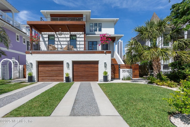 3516 1st St S, Jacksonville Beach, FL 32250 - view of front of home featuring an attached garage, a front yard, a balcony, brick siding, and driveway