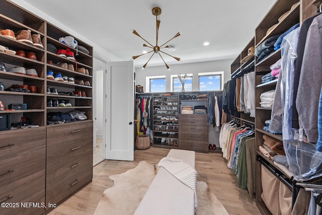 3516 1st St S, Jacksonville Beach, FL 32250 - spacious closet featuring light wood-style floors and an inviting chandelier