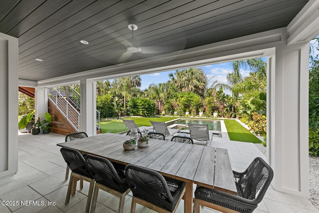 3516 1st St S, Jacksonville Beach, FL 32250 - view of patio / terrace featuring an outdoor pool, stairs, outdoor dining area, and a ceiling fan