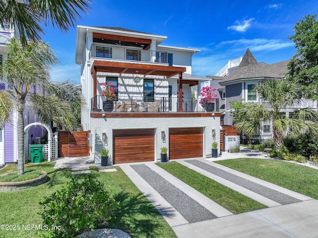 3516 1st St S, Jacksonville Beach, FL 32250 - contemporary home featuring an attached garage, brick siding, a balcony, concrete driveway, and a front yard