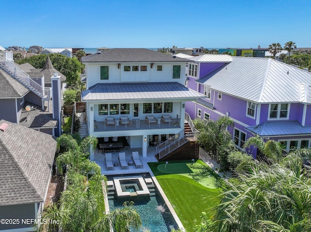 3516 1st St S, Jacksonville Beach, FL 32250 - back of property featuring a residential view, stucco siding, metal roof, stairway, and a standing seam roof