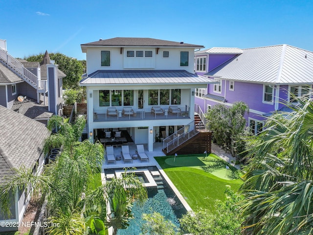 3516 1st St S, Jacksonville Beach, FL 32250 - back of property with stucco siding, metal roof, a patio area, a standing seam roof, and stairs