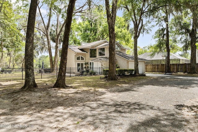 97282 Yorkshire Dr, Yulee, FL 32097 - view of front facade with a garage, driveway, fence, and stucco siding