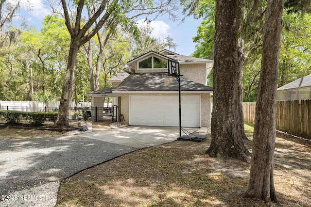 97282 Yorkshire Dr, Yulee, FL 32097 - view of front of house with concrete driveway, an attached garage, fence, stucco siding, and a shingled roof