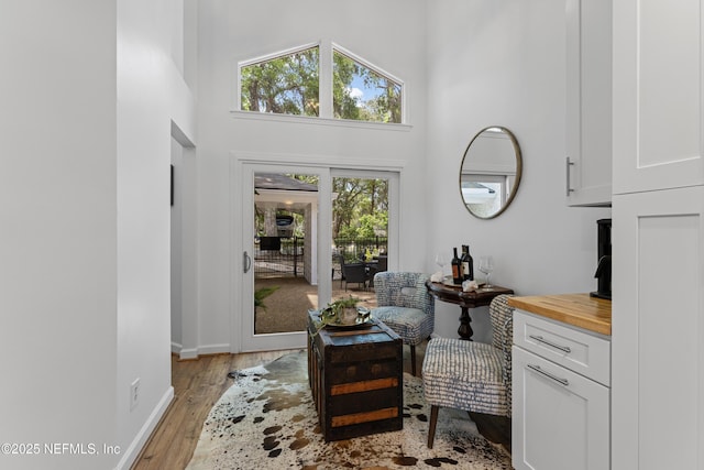 97282 Yorkshire Dr, Yulee, FL 32097 - sitting room with a towering ceiling, light wood-type flooring, and baseboards