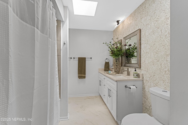 97282 Yorkshire Dr, Yulee, FL 32097 - bathroom featuring a skylight, toilet, wallpapered walls, marble finish flooring, and vanity