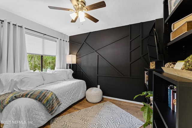 97282 Yorkshire Dr, Yulee, FL 32097 - bedroom with wood finished floors, a decorative wall, and a ceiling fan