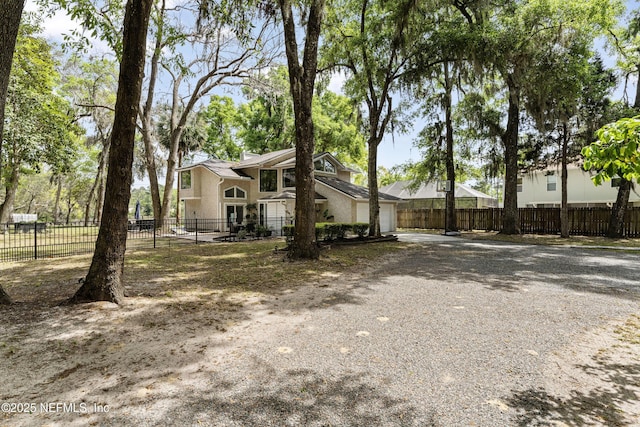 97282 Yorkshire Dr, Yulee, FL 32097 - view of front of house featuring driveway, an attached garage, and fence