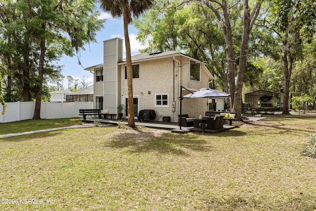97282 Yorkshire Dr, Yulee, FL 32097 - back of house featuring a carport, a patio, stucco siding, a chimney, and a gazebo