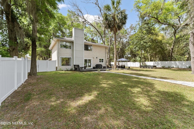 97282 Yorkshire Dr, Yulee, FL 32097 - rear view of house with stucco siding and a chimney