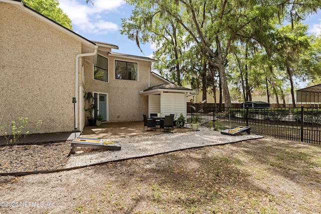 97282 Yorkshire Dr, Yulee, FL 32097 - rear view of house featuring stucco siding, fence, and a patio area