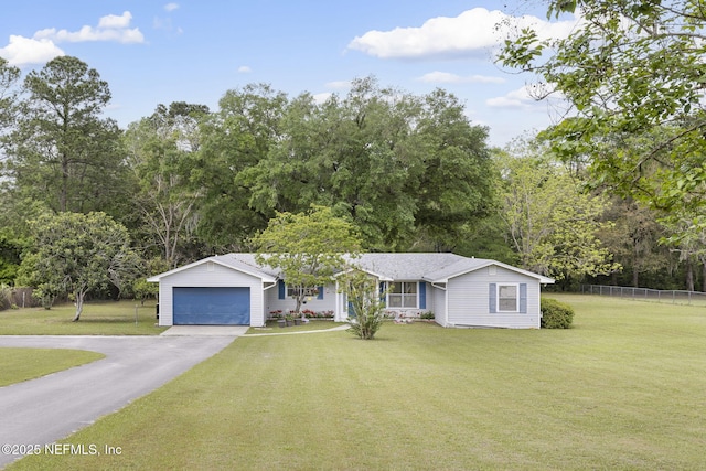 ranch-style home with a front yard, fence, and a garage