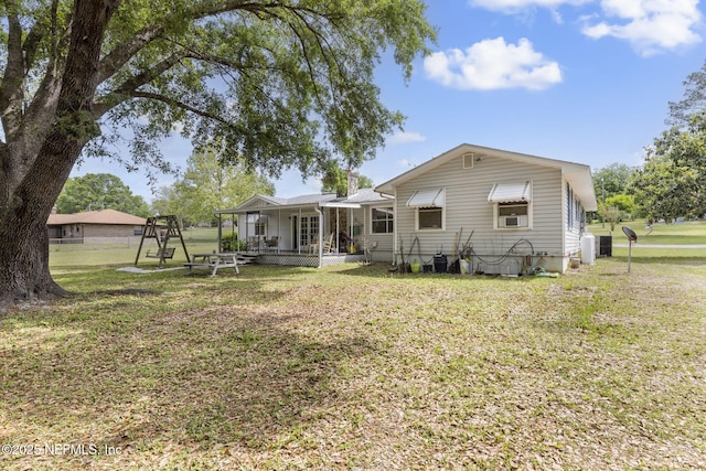 back of property with a lawn
