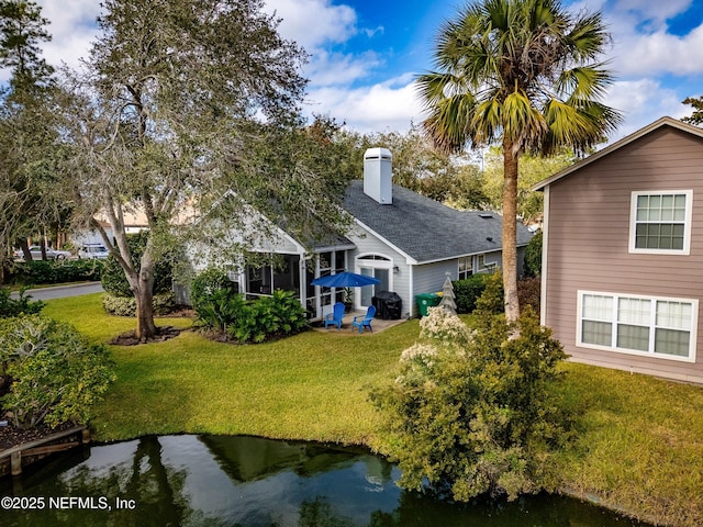 1886 Mourning Dove Ln, Jacksonville Beach, FL 32250 - rear view of property featuring a yard and a chimney
