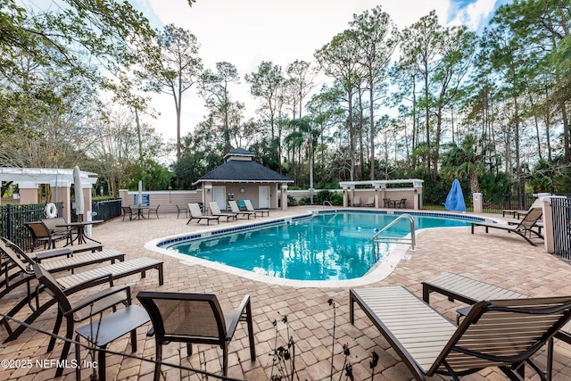 1886 Mourning Dove Ln, Jacksonville Beach, FL 32250 - community pool with fence, a patio area, and view of wooded area