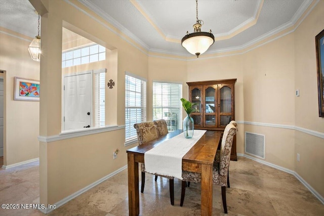 1886 Mourning Dove Ln, Jacksonville Beach, FL 32250 - dining room featuring a tray ceiling, crown molding, baseboards, and a high ceiling