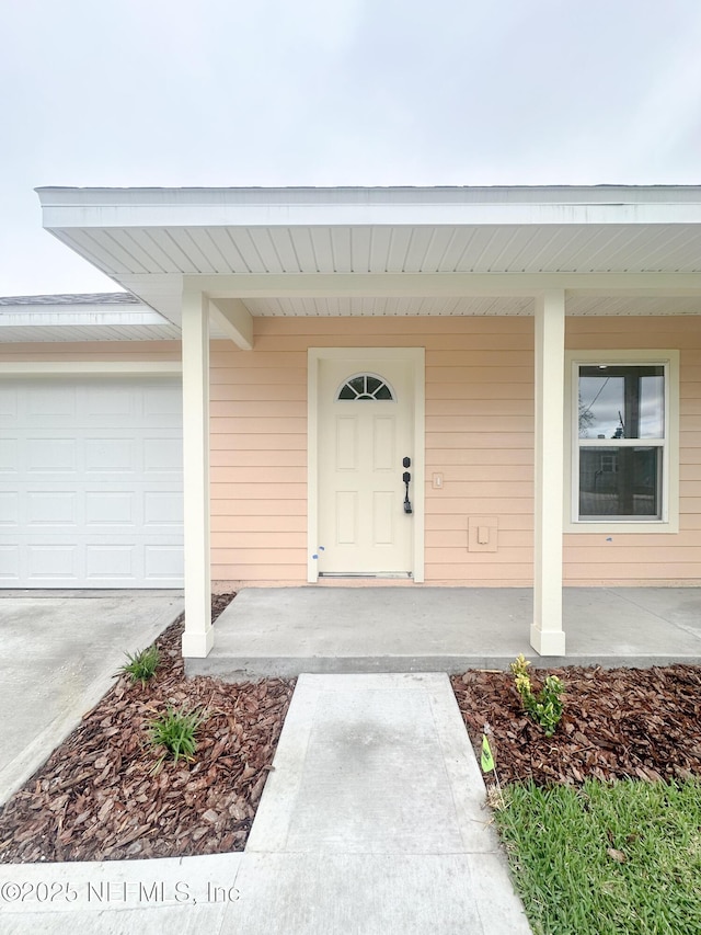116 Moseley Ave, Palatka, FL 32177 - property entrance with an attached garage and a porch
