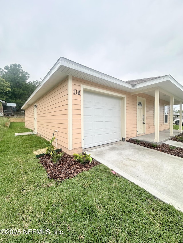 116 Moseley Ave, Palatka, FL 32177 - view of side of property featuring a lawn, driveway, and an attached garage