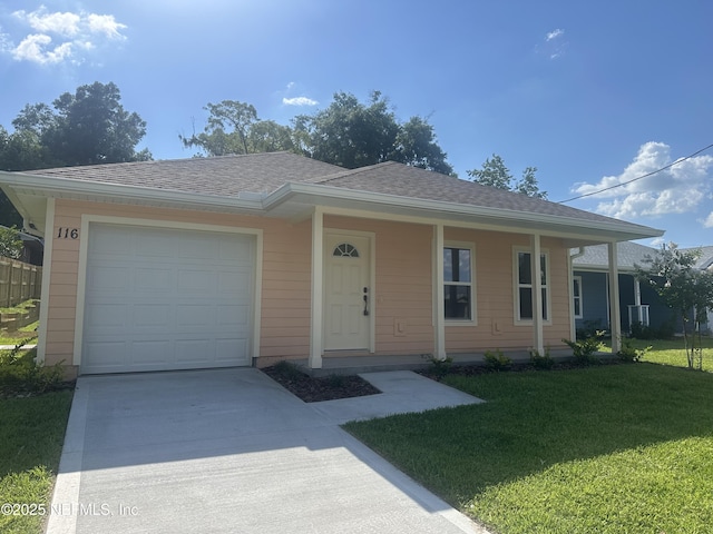 116 Moseley Ave, Palatka, FL 32177 - view of front of house with concrete driveway, a front lawn, an attached garage, and roof with shingles