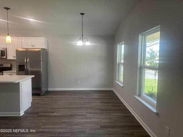116 Moseley Ave, Palatka, FL 32177 - kitchen with appliances with stainless steel finishes, dark wood finished floors, white cabinetry, and decorative light fixtures