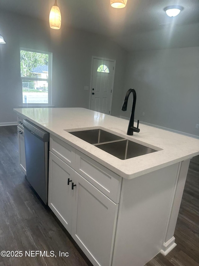 116 Moseley Ave, Palatka, FL 32177 - kitchen with stainless steel dishwasher, a sink, dark wood-style floors, white cabinets, and light stone counters