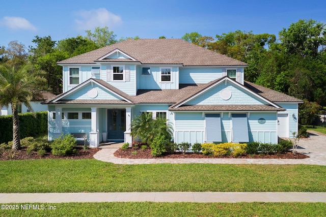 247 Vale Dr, Saint Augustine, FL 32095 - view of front facade with a front lawn, a shingled roof, and french doors