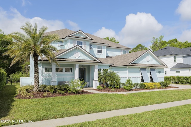247 Vale Dr, Saint Augustine, FL 32095 - view of front of house with a front lawn and a shingled roof